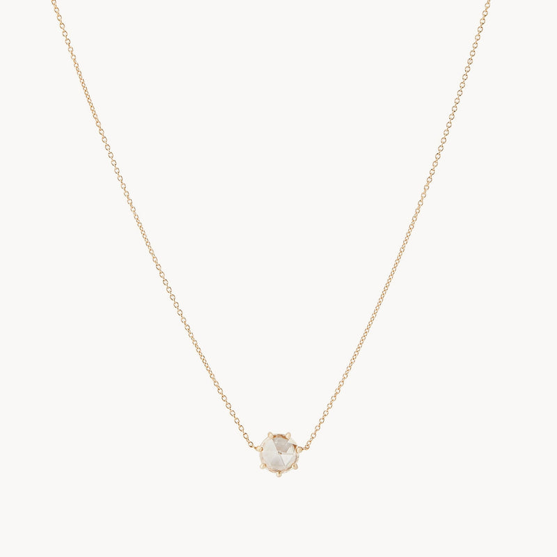 The extra large supernova necklace in 14k yellow gold by bluboho is a delicate piece featuring a single, hexagonal-shaped transparent gemstone pendant at its center. Its minimalist design highlights the elegance and simplicity of the necklace, with a thin chain that ensures the gemstone remains the focal point.