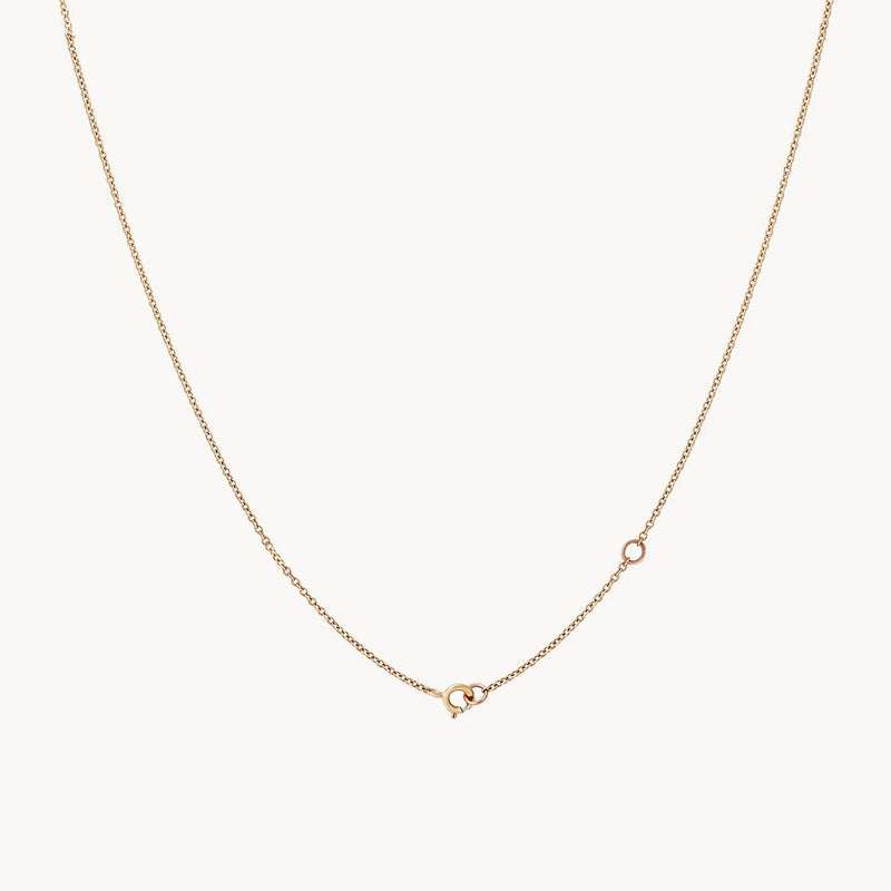 The Dainty Diamond Nova Necklace by bluboho is a 14k yellow gold chain with a small clasp visible near the bottom center. The chain has a subtle shine and appears lightweight and minimalistic in design. The plain white background emphasizes the simplicity of this delicate necklace.