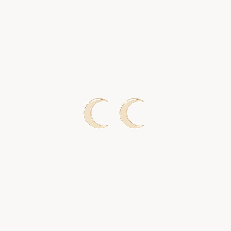 A pair of the "Everyday Larger Crescent Moon Earrings - 14k Yellow Gold" by bluboho displayed against a plain white background. The earrings feature a smooth, polished surface and are symmetrical in their shape and design.