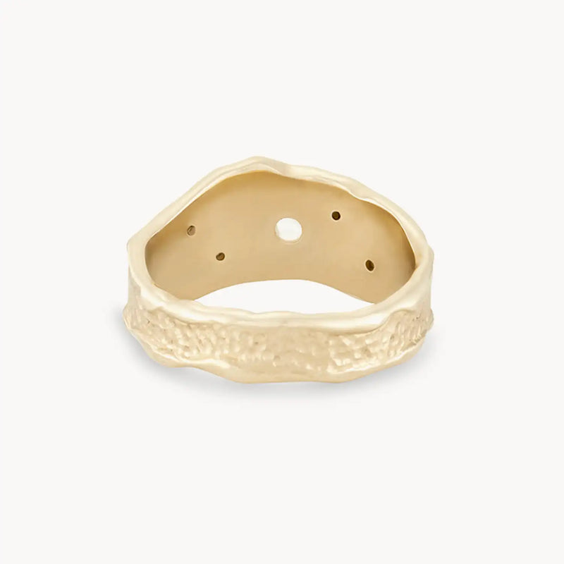 A golden Luminous Honey Diamond Ring from bluboho, crafted in 14k yellow gold with white diamonds. The ring features a rough, uneven texture and three small holes inside the band, all displayed on a plain white background. The rugged design gives it a unique, artisanal appearance.