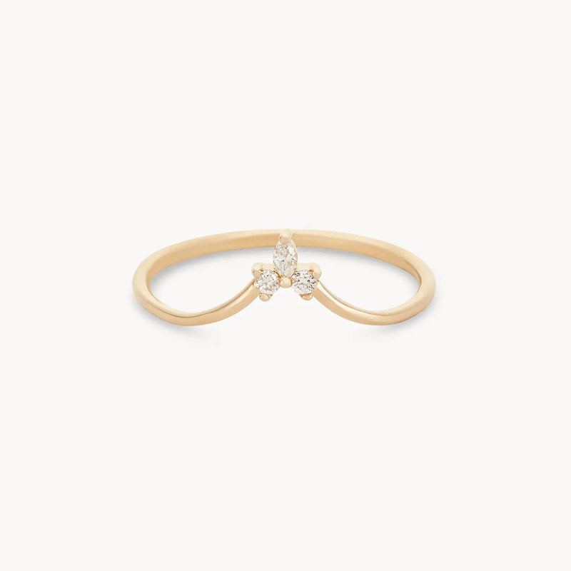 The Mini Moonbow Ring by bluboho showcases a delicate 14k yellow gold band, featuring a central marquise-cut diamond accented by three smaller round diamonds on each side in a symmetrical, floral-inspired design. The thin band is gracefully curved.