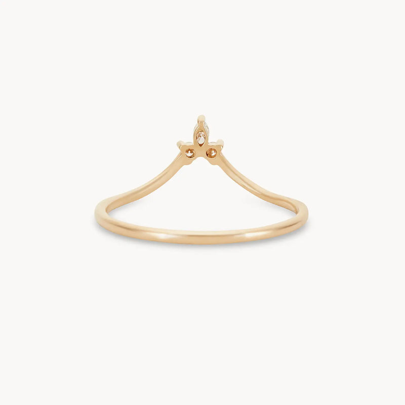 The bluboho Mini Moonbow Ring in 14k yellow gold is a delicate piece with a simple yet elegant design, featuring a small, crown-like structure at the top. Its smooth, thin band narrows slightly below the crown accent, giving it a minimalist and refined look.