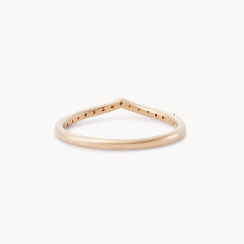 A thin 14k rose gold ring shaped like a delicate chevron, known as the peak eternity band, from beloved by bluboho. The band is smooth and polished, with no additional decorations or stones. The ring's V-shaped design gives it a modern and minimalist appearance.