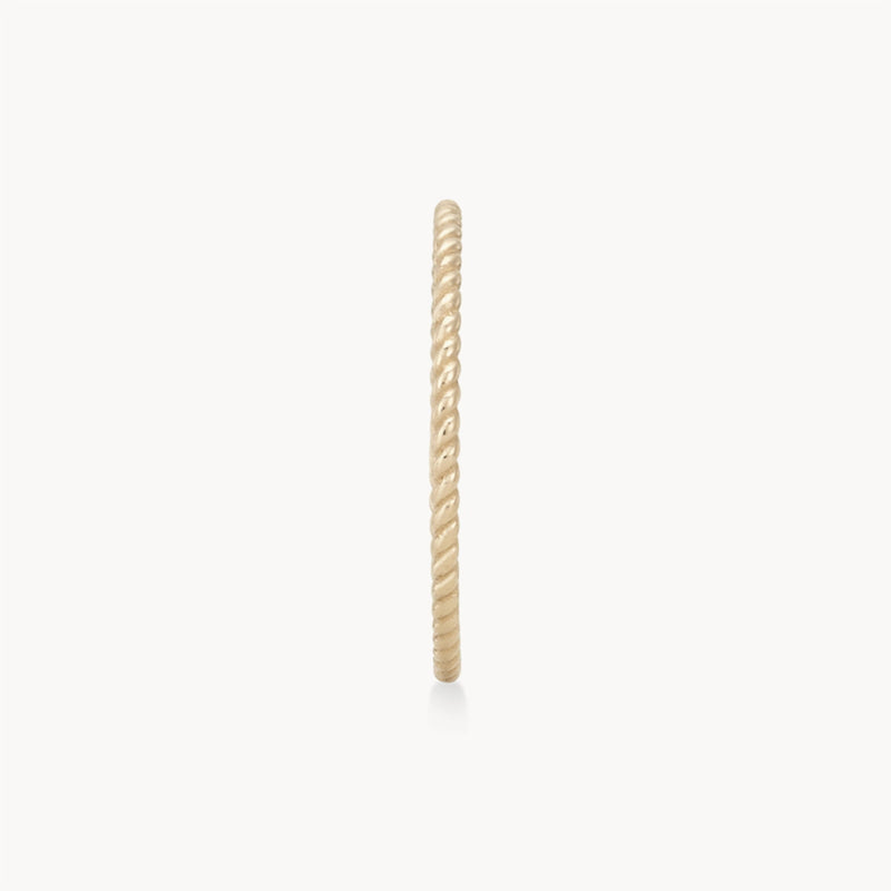 A close-up view of a twisted stacking ring - 10k yellow gold by bluboho featuring a twisted rope design, displayed against a plain white background.